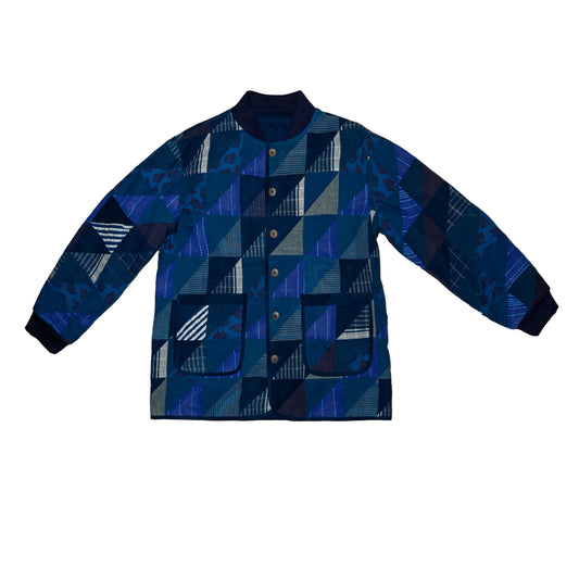 A reversible patchwork jacket made in matching shades of dark blue with inner lining made of contrast hand printed cotton. 