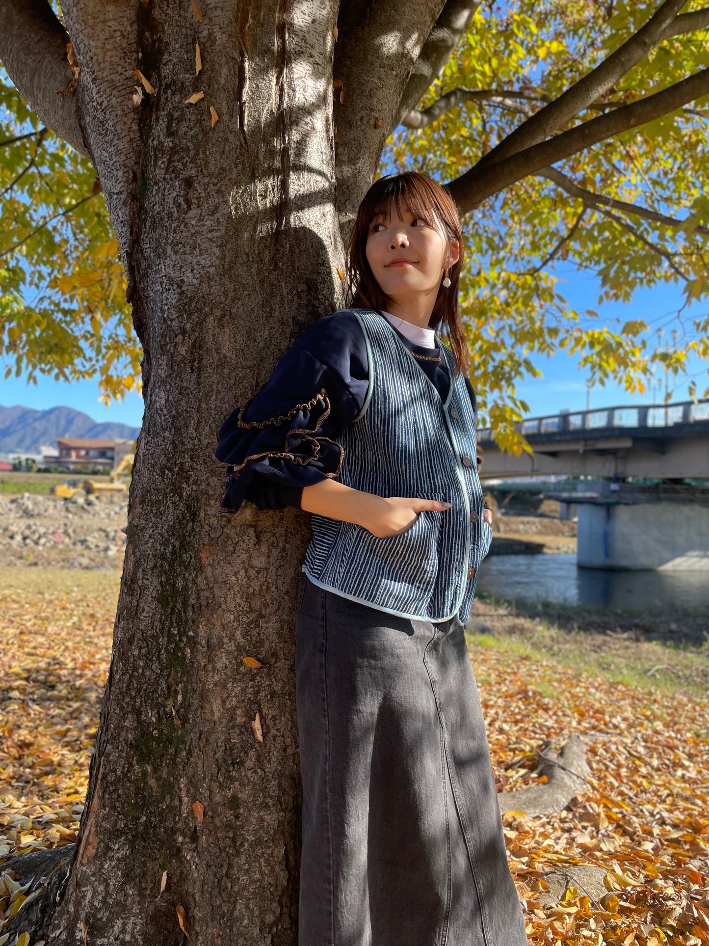 Blue hand quilted reversible vest style jacket with hand block print fabric on one side and hand done shibori on the other side. it has pockets on both sides. 