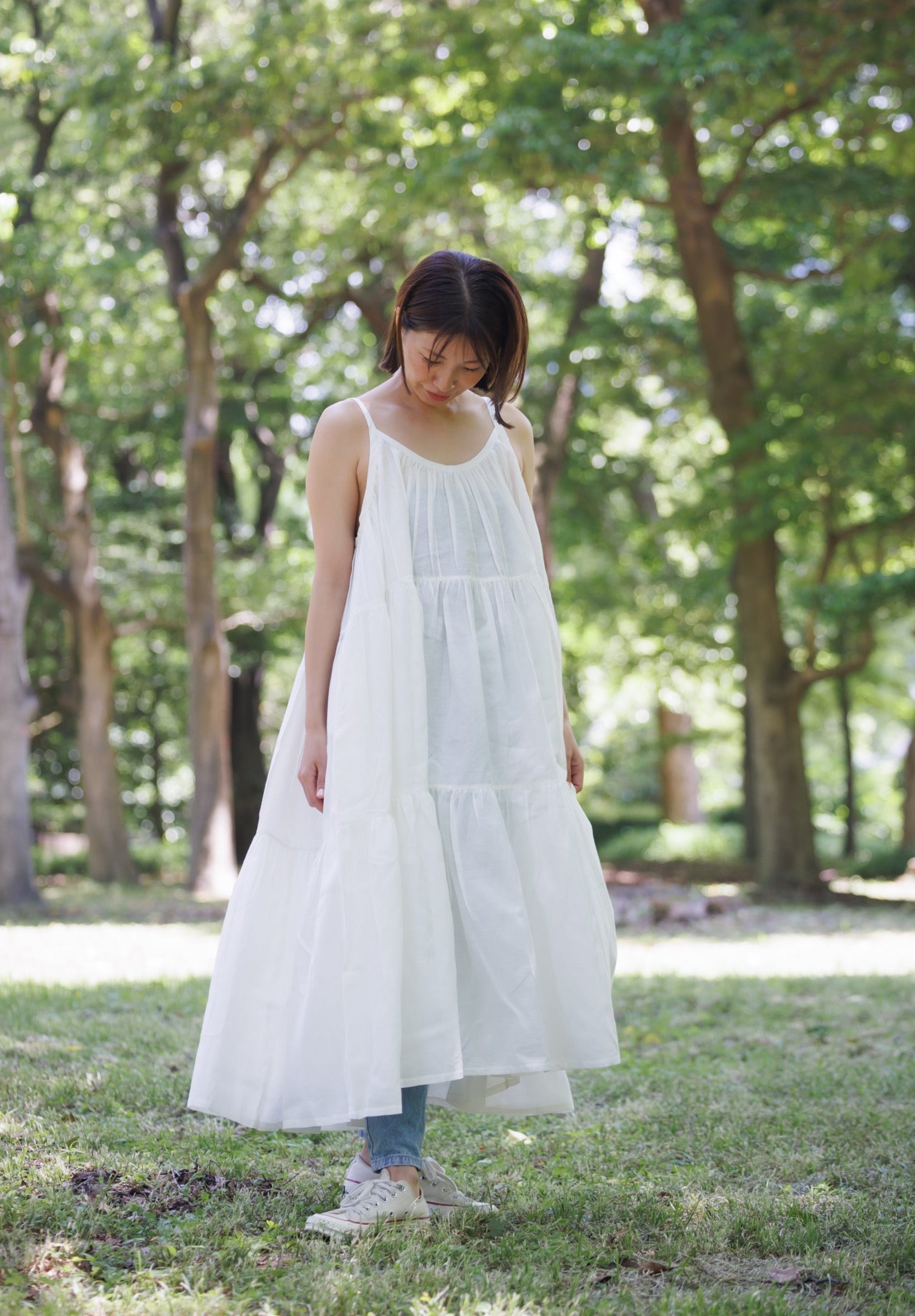 White three tier dress with comfortable straps and a very large fllare. 