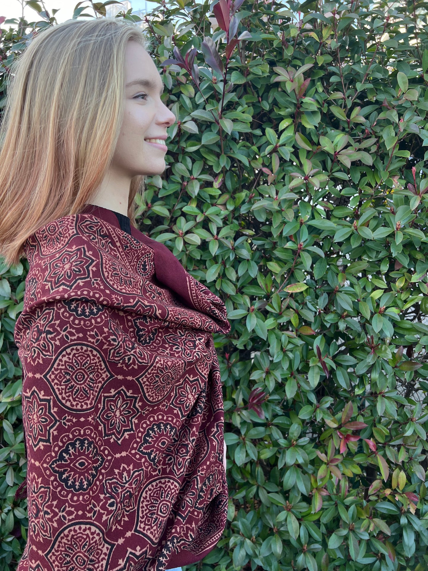 hand woven merino wool shawl with all over ajrakh hand block print in shades of deep red using natural colours. 